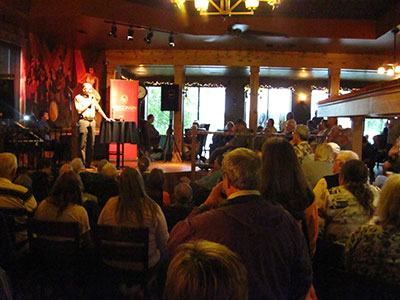 Man presenting to a packed room at the Science on Tap Program